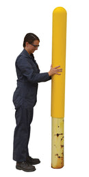 Woman sliding plastic bollard cover over bollard