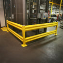 Yellow safety barrier in a warehouse setting.