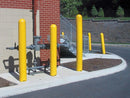 Several plastic bollard covers on a curb